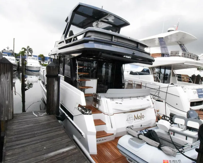 Slide: The Image of 2024 OKEAN 52 yacht docked, featuring sleek design and modern amenities. - 27