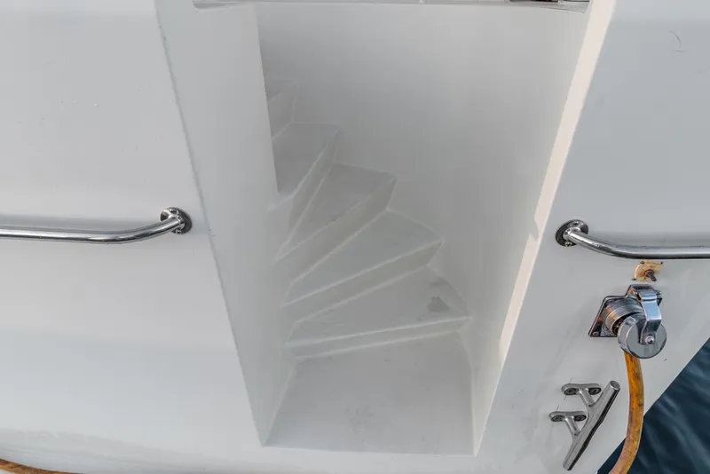 Slide: The Image of Staircase on 2006 Solander Eclipse Steel Trawler with metal handrails and water hose connection. - 52