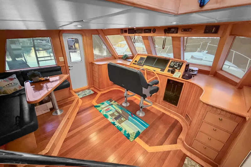 Slide: The Image of Interior of 2006 Solander Eclipse Steel Trawler with wooden helm and seating area. - 21