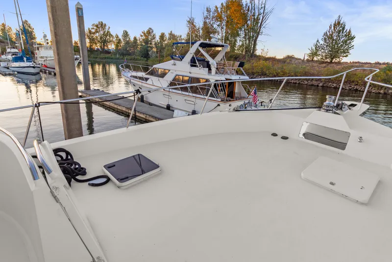 Slide: The Image of 2006 Solander Eclipse Steel Trawler docked at marina, surrounded by serene water and trees. - 62
