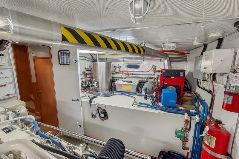 Slide: The Image of Engine room of 2006 Solander Eclipse Steel Trawler, featuring machinery and safety equipment. - 50
