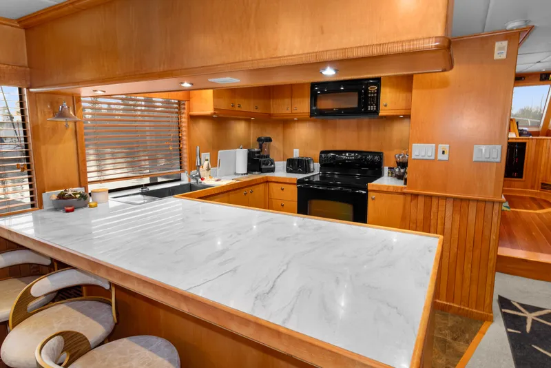 Slide: The Image of Luxurious kitchen interior of 2006 Solander Eclipse Steel Trawler with marble countertop and wooden cabinetry. - 12