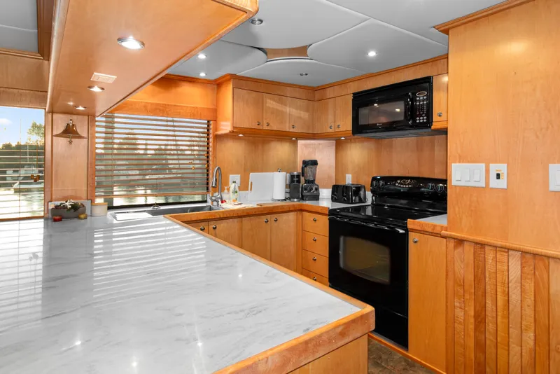 Slide: The Image of Luxurious kitchen interior of 2006 Solander Eclipse Steel Trawler with modern appliances and wood cabinetry. - 6
