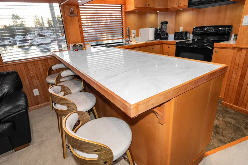 Slide: The Image of Luxurious kitchen interior of 2006 Solander Eclipse Steel Trawler with marble countertop and modern appliances. - 5