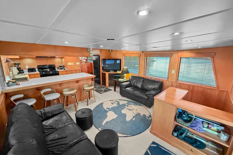 Slide: The Image of Luxurious interior of 2006 Solander Eclipse Steel Trawler with modern furnishings and world map rug. - 16