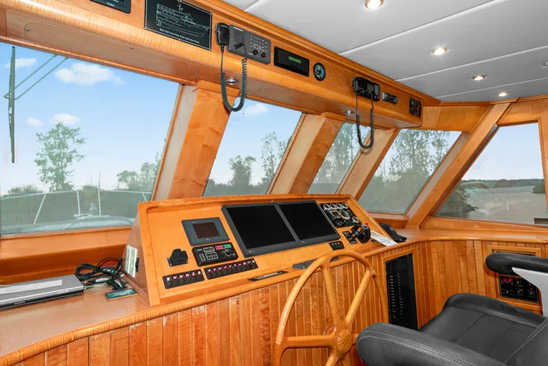 Slide: The Image of Interior of 2006 Solander Eclipse Steel Trawler helm with wooden dashboard and navigation equipment. - 18