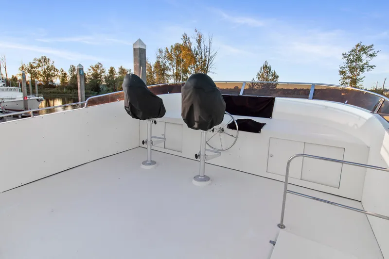 Slide: The Image of Upper deck of 2006 Solander Eclipse Steel Trawler with covered helm chairs and steering wheel. - 67