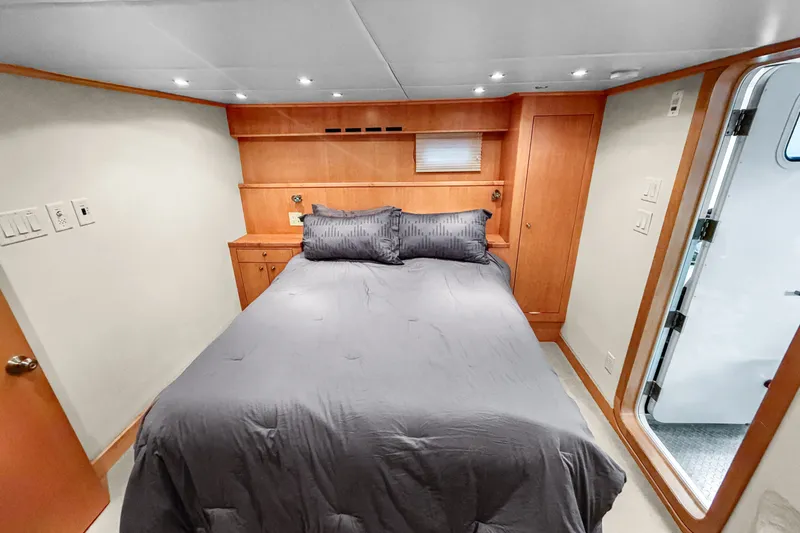 Slide: The Image of Cozy bedroom in 2006 Solander Eclipse Steel Trawler with modern wood paneling and gray bedding. - 31