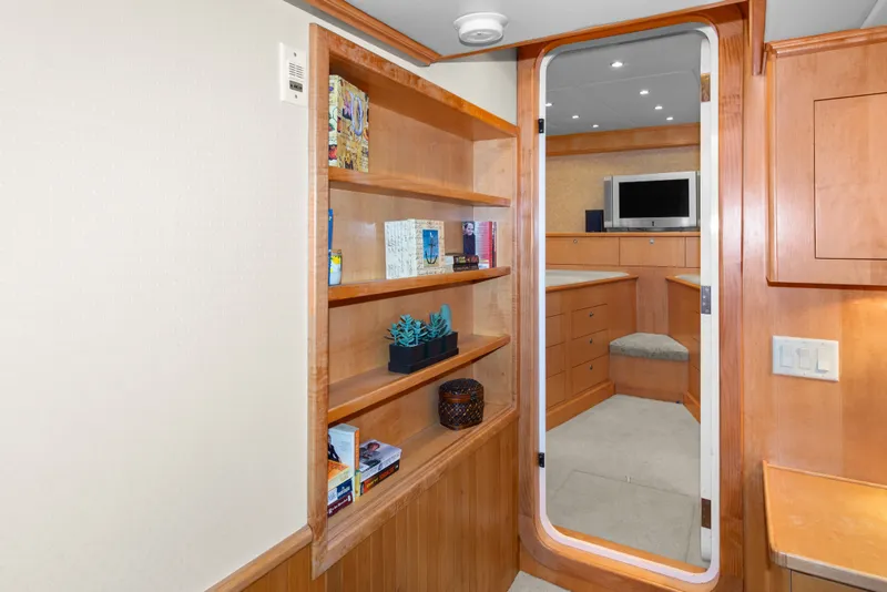 Slide: The Image of Interior of 2006 Solander Eclipse Steel Trawler with wooden shelves and cozy seating area. - 26