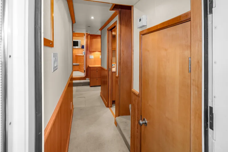 Slide: The Image of Interior hallway of 2006 Solander Eclipse Steel Trawler, featuring wooden doors and cabinetry. - 36