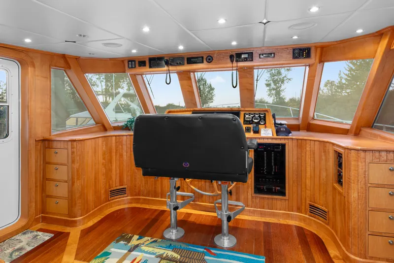 Slide: The Image of Pilothouse interior of 2006 Solander Eclipse Steel Trawler with wood paneling and navigation controls. - 20