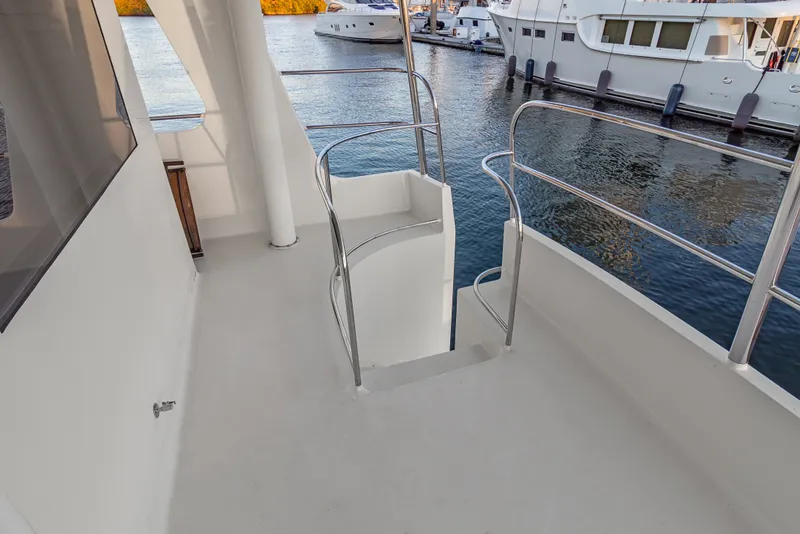 Slide: The Image of Staircase on 2006 Solander Eclipse Steel Trawler, overlooking marina with docked boats. - 53