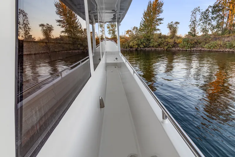Slide: The Image of Side deck view of 2006 Solander Eclipse Steel Trawler on calm water. - 60