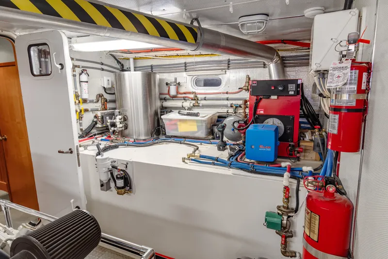 Slide: The Image of Engine room of 2006 Solander Eclipse Steel Trawler, featuring equipment and fire extinguishers. - 45
