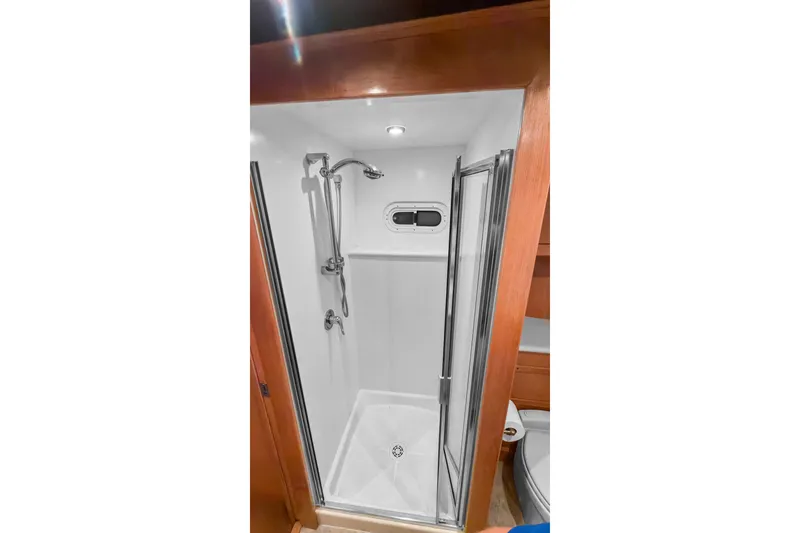Slide: The Image of Shower area in 2006 Solander Eclipse Steel Trawler, featuring modern fixtures and wooden accents. - 35