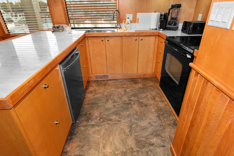 Slide: The Image of Kitchen interior of 2006 Solander Eclipse Steel Trawler with wooden cabinets and modern appliances. - 7