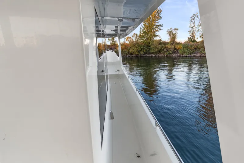 Slide: The Image of Side view of 2006 Solander Eclipse Steel Trawler on calm water, surrounded by trees. - 59