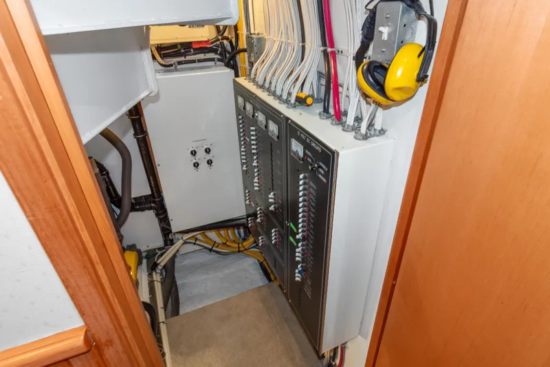 Slide: The Image of Electrical panel inside 2006 Solander Eclipse Steel Trawler, featuring wiring and safety equipment. - 42