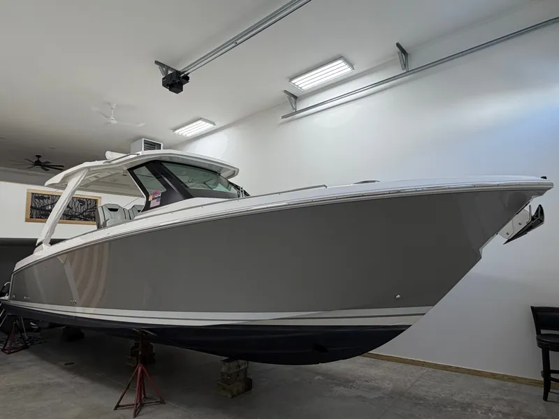 The Image of A 2023 Tiara Yachts 34 LS is in a garage on stands. - 0