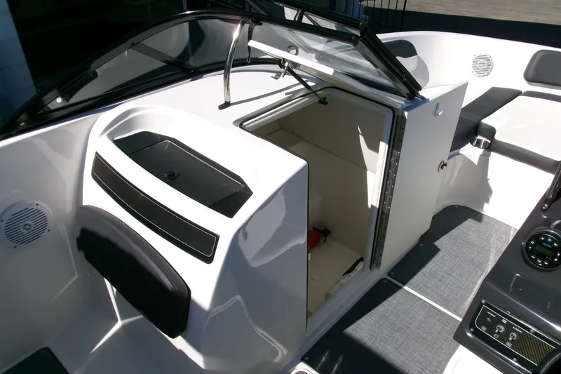Slide: The Image of 2022 Bayliner VR6 Bowrider OB interior with open storage compartment and seating area. - 10