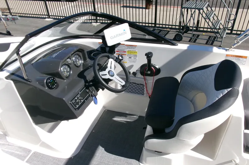 Slide: The Image of 2022 Bayliner VR6 Bowrider OB cockpit with steering wheel, gauges, and comfortable seating. - 7