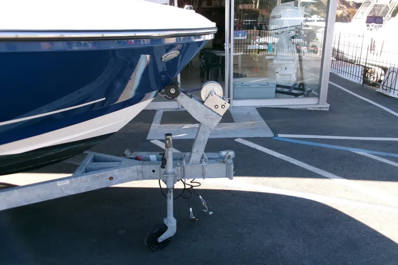 Slide: The Image of 2022 Bayliner VR6 Bowrider OB on trailer, parked outside a showroom. - 24