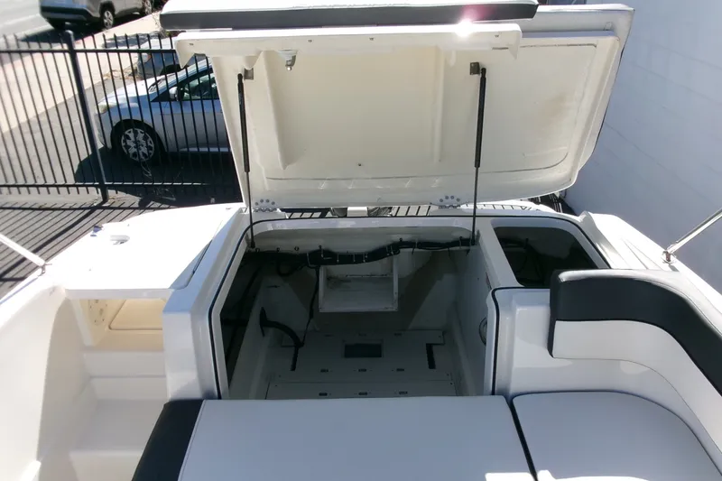 Slide: The Image of 2022 Bayliner VR6 Bowrider OB with open storage compartment, showcasing spacious interior design. - 19