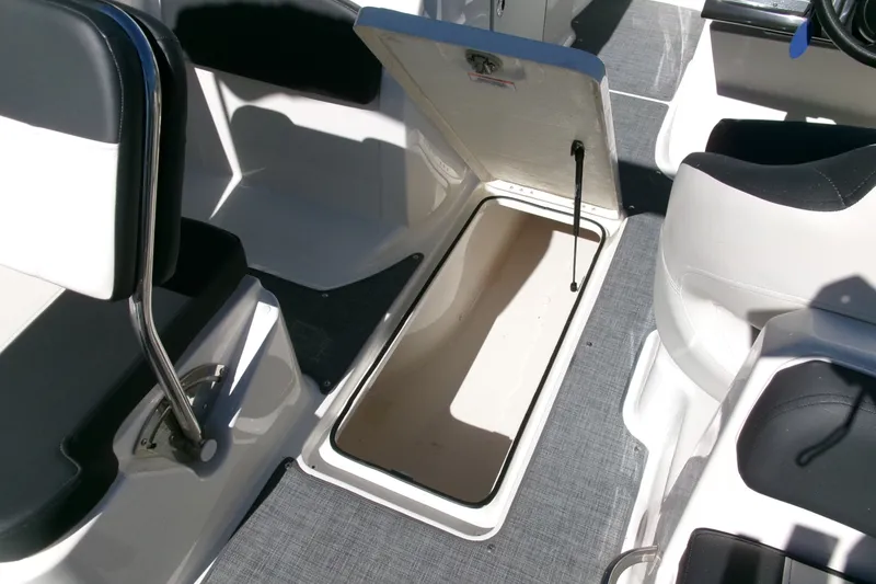 Slide: The Image of 2022 Bayliner VR6 Bowrider OB interior with open storage compartment and seating. - 12