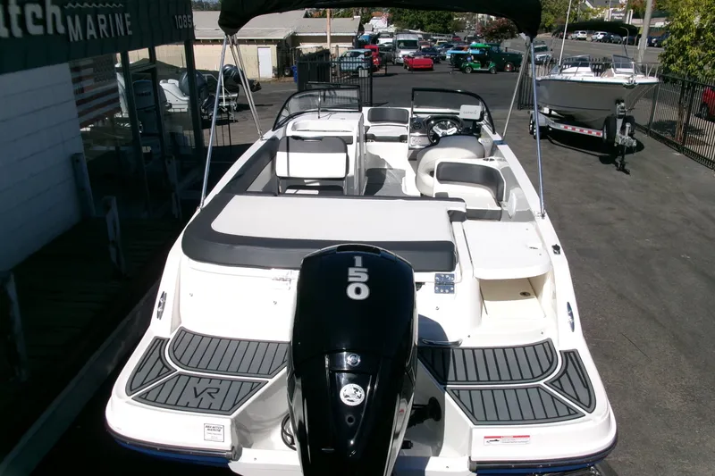 Slide: The Image of 2022 Bayliner VR6 Bowrider OB with 150 HP engine, docked at a marina. - 27