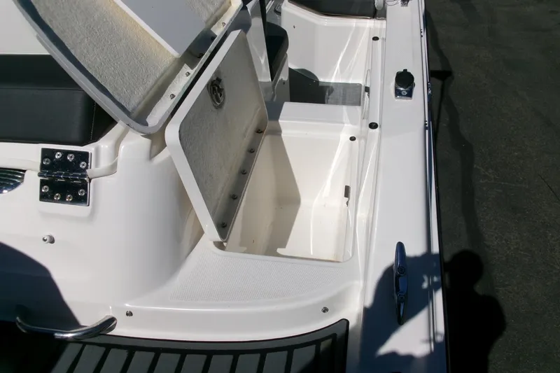 Slide: The Image of Open storage compartment on 2022 Bayliner VR6 Bowrider OB boat deck. - 21