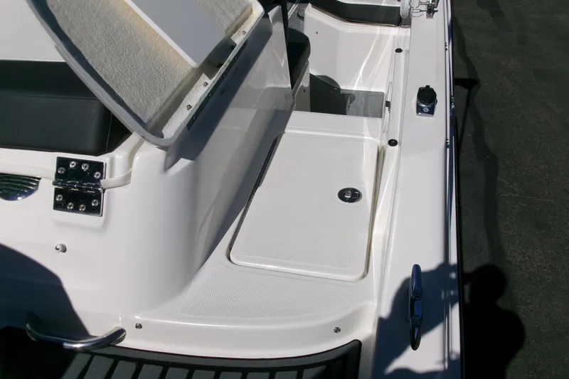 Slide: The Image of 2022 Bayliner VR6 Bowrider OB boat interior with open storage compartment. - 20