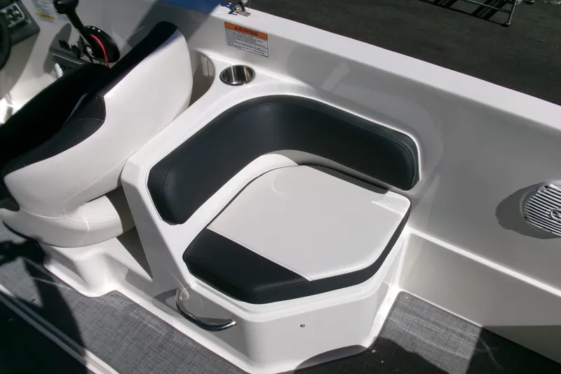 Slide: The Image of 2022 Bayliner VR6 Bowrider OB interior seating with cup holder and speaker. - 8