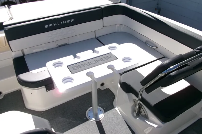 Slide: The Image of 2022 Bayliner VR6 Bowrider OB interior with seating and table, featuring cup holders. - 17