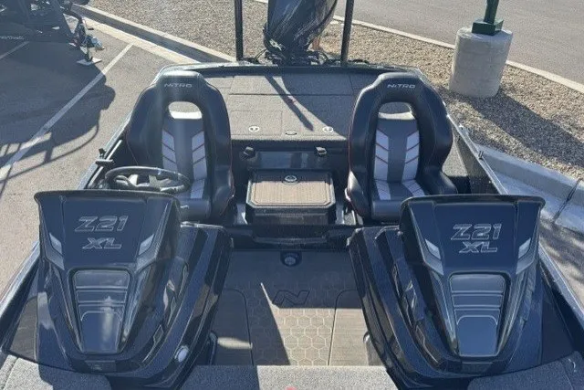 Slide: The Image of 2024 Nitro Z21 XL Pro boat interior with dual seats and steering wheel. - 4
