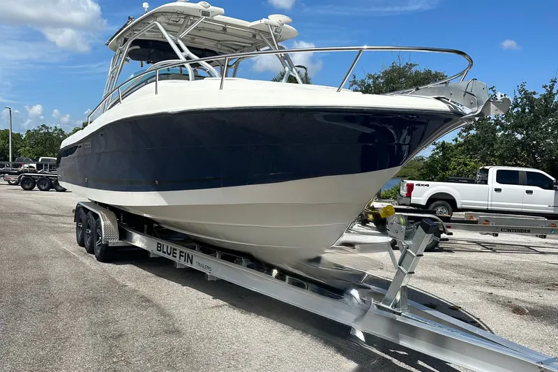 Slide: The Image of 2005 Hydra-Sports Vector 3300 VX boat on trailer, parked outdoors under blue sky. - 20