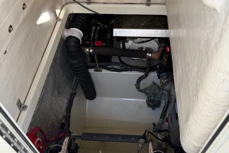 Slide: The Image of Engine compartment of a 2005 Hydra-Sports Vector 3300 VX boat, showing mechanical components. - 10