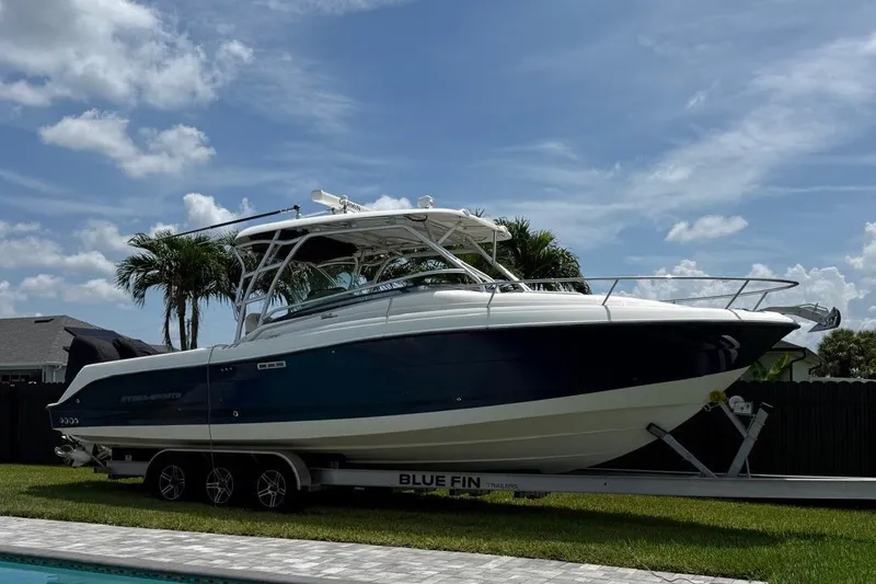 The Image of 2005 Hydra-Sports Vector 3300 VX boat on trailer, parked outdoors under a clear sky. - 0