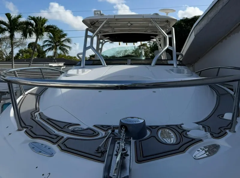 Slide: The Image of 2005 Hydra-Sports Vector 3300 VX boat with sleek design, docked under a clear sky. - 19