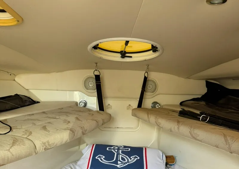 Slide: The Image of Interior cabin of 2005 Hydra-Sports Vector 3300 VX with nautical-themed bedding. - 16