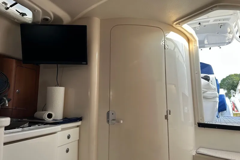 Slide: The Image of Interior of 2001 Intrepid 348 Walkaround boat with TV and kitchenette. - 16