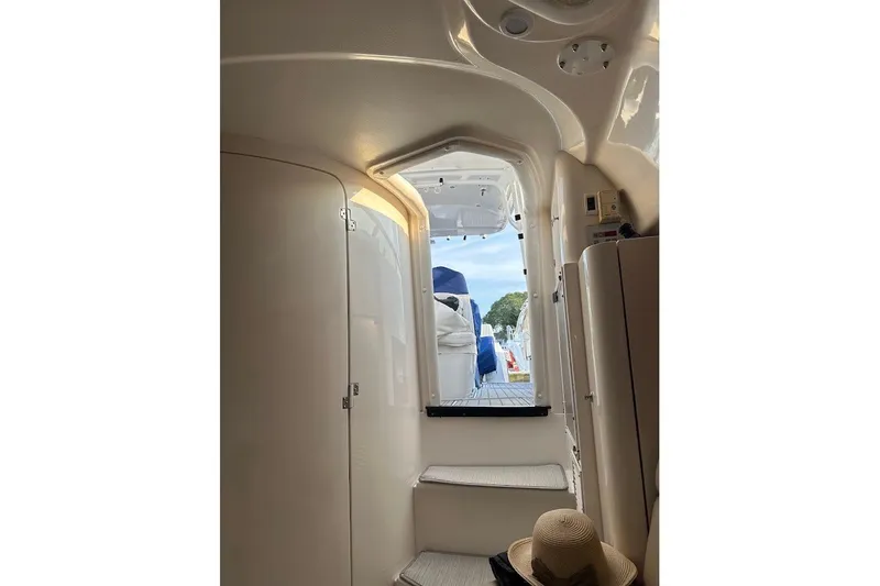 Slide: The Image of Interior view of a 2001 Intrepid 348 Walkaround boat, showing cabin entrance and seating. - 14