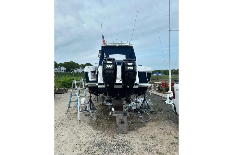Slide: The Image of 2001 Intrepid 348 Walkaround boat with twin 300 horsepower engines on land. - 6