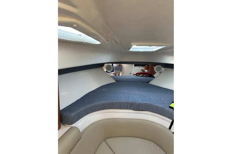 Slide: The Image of 2001 Intrepid 348 Walkaround cabin interior with bed and seating area. - 15