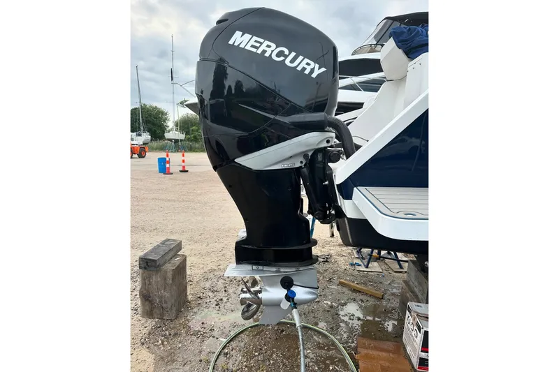 Slide: The Image of 2001 Intrepid 348 Walkaround with Mercury outboard engine in a boatyard setting. - 7