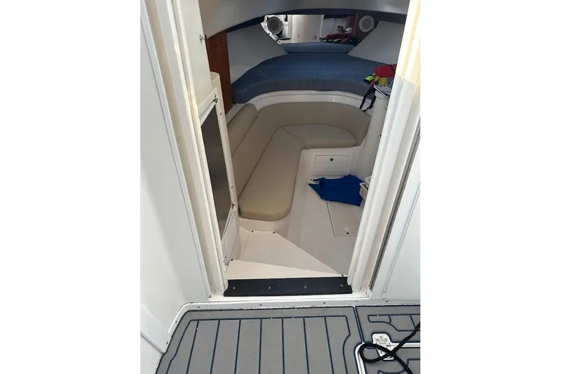 Slide: The Image of 2001 Intrepid 348 Walkaround cabin interior with seating and storage. - 13