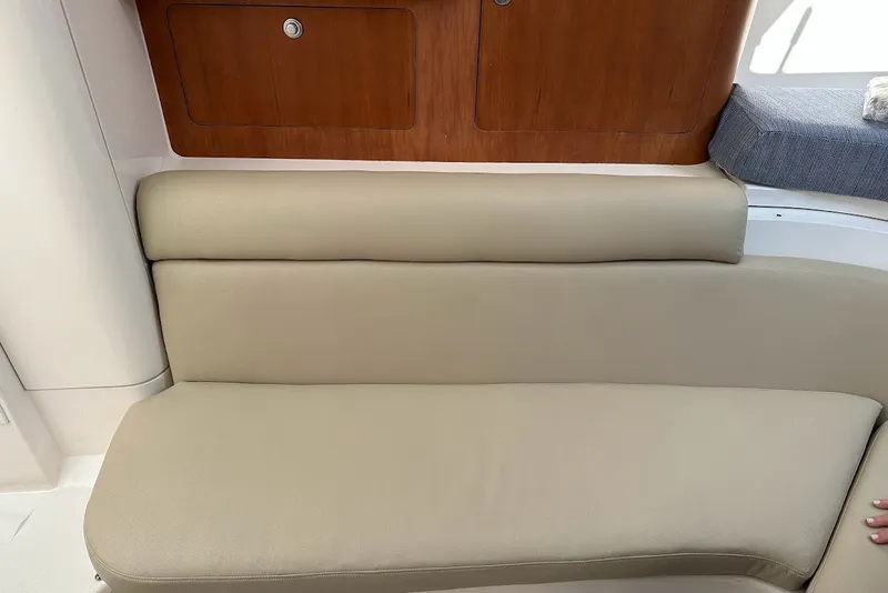 Slide: The Image of Interior seating of a 2001 Intrepid 348 Walkaround boat with beige upholstery. - 11