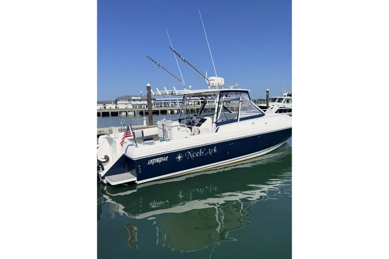 The Image of 2001 Intrepid 348 Walkaround boat docked in marina, clear blue sky. - 0