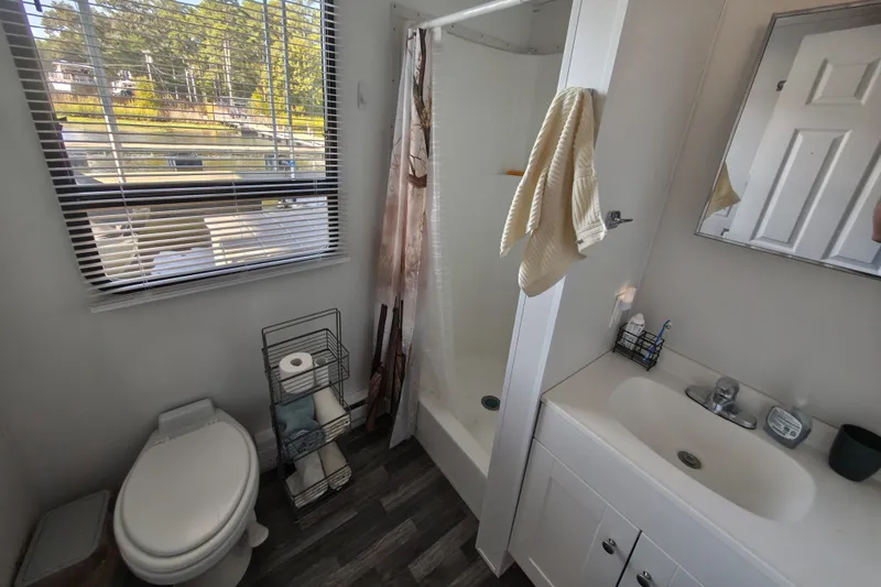 Slide: The Image of Modern bathroom in 2023 Catamaran Cruisers 1245 with shower, toilet, and sink. - 6