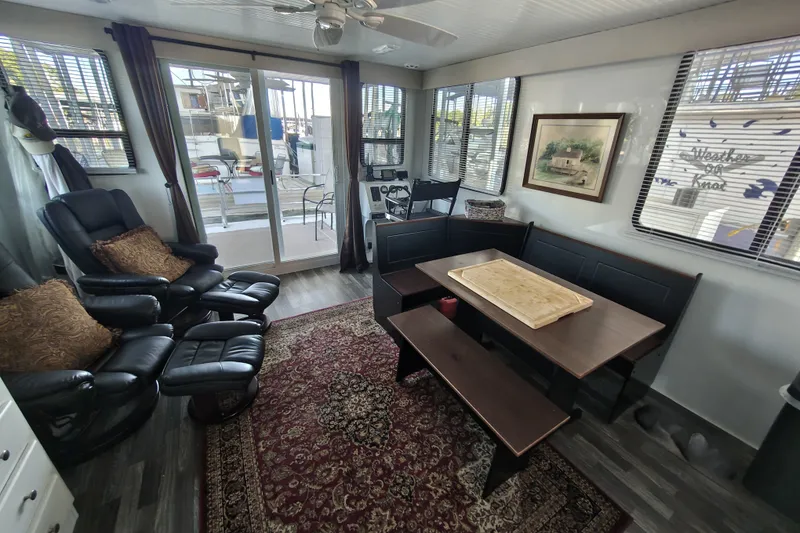 Slide: The Image of Interior of 2023 Catamaran Cruisers 1245 with cozy seating and dining area. - 3