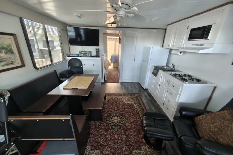 The Image of Interior of 2023 Catamaran Cruisers 1245 with kitchen, dining area, and cozy seating. - 0